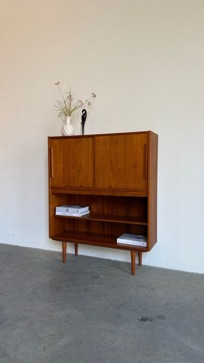 
                  
                    Vintage teak boekenkast met schuifdeuren - LOUI
                  
                